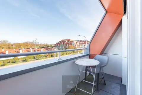 Recent duplex apartment with one bedroom and sleeping area.